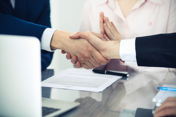 Business people shaking hands finishing up a meeting. Handshake at successful negotiation