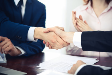 Business people shaking hands finishing up a meeting. Handshake at successful negotiation
