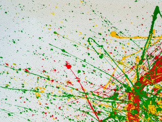 splashes of red and yellow green paint on a white background