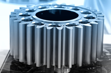 Industrial gear on a support. Blue toned