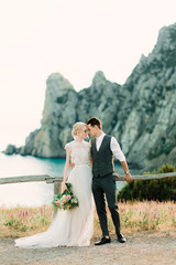 Beautiful portrait of bride and groom hug each other tender