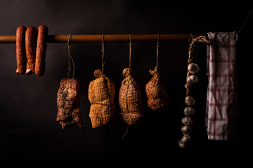 Traditionally smoked meats, ham, sausage, bacon in a smokehouse.