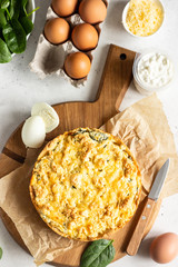 Tart or pie with spinach, ricotta and eggs.  Torta Pascualina, typical Italian Easter food. Light grey background. Copy space.
