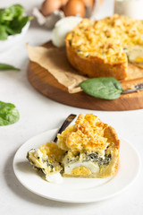 Tart or pie with spinach, ricotta and eggs.  Torta Pascualina, typical Italian Easter food. Light grey background. Copy space.