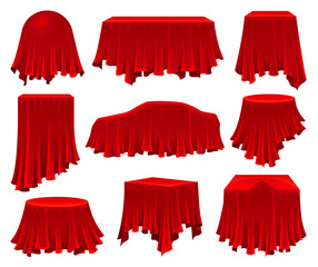 Collection of objects hidden under red cloth.
