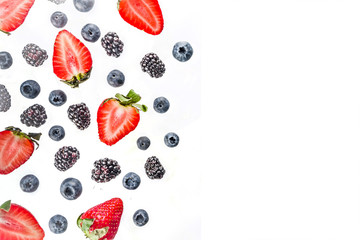 Fresh berries pattern - blueberries, strawberries, blackberries. On white background, top view, flatlay layout