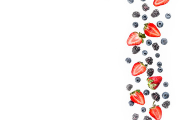 Fresh berries pattern - blueberries, strawberries, blackberries. On white background, top view, flatlay layout