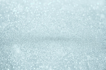 Silver white glittering Christmas lights. Blurred abstract background