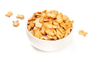 Salty goldfish crackers in a bowl on a white background with a place for text
