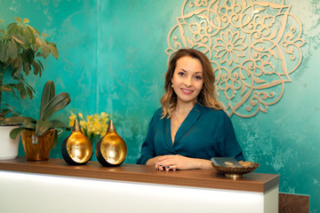 Beautiful woman at reception desk in yoga and wellness center