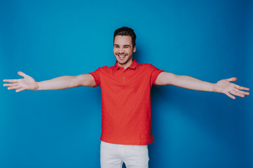 Fototapeta premium Half length of smiling man posing for camera in studio