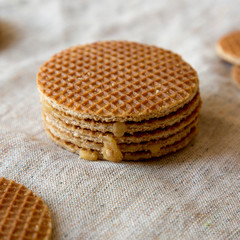 Homemade Dutch stroopwafels on cloth, side view. Close-up.