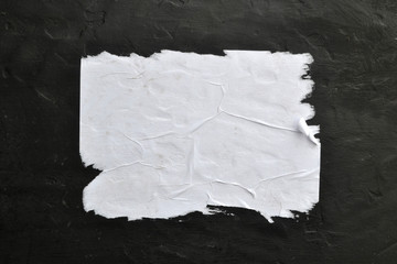 White sheet of paper on a black background.