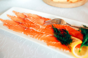 salmon sliced on a white plate served in a restaurant