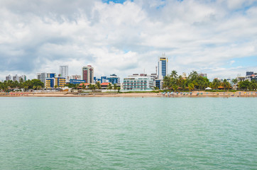View to the Praia do Bessa beach and the beachfront buildings of the city of Joao Pessoa. Beachfront city.