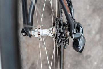 Fototapeta premium Road bicycle rear wheel hub with multi speed cassette and chain with spokes and rim