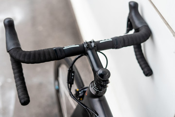 Black road bike handlebar with brake levers and cables
