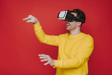 Side view of man gesticulating with hands while situating in virtual reality