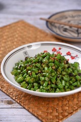 green beans in bowl on wooden background