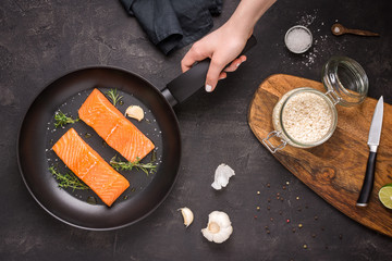 Salmon Steaks Fresh and Raw in Frying Pan with Thyme and Garlic