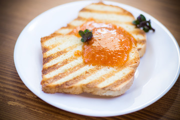 fried toast with apricot jam in a plate