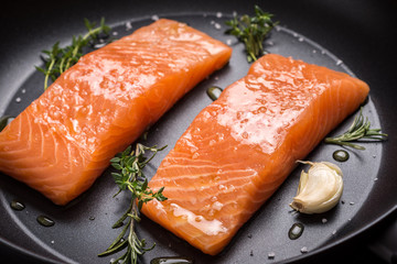 Salmon Steaks Fresh and Raw in Frying Pan with Thyme and Garlic