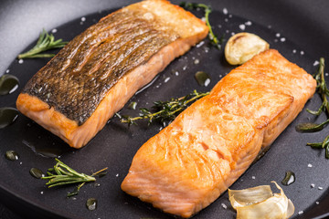 Grilled Salmon Fillets in Frying Pan with Thyme and Garlic