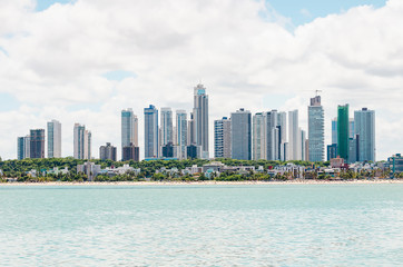 View of the coast, beach and the city on background at Joao Pessoa PB Brazil. Touristic city of Brazilian northeast with beautiful beaches. View from the sea to the city.