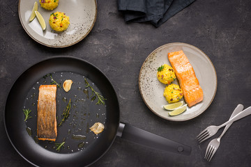 Grilled Salmon Fillet with Saffron Risotto on Dark Background