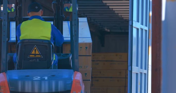 In the woodworking plant for the production of plywood and chipboard is loads by forklift wood products into the cargo truck 