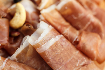 Closeup sliced fresh rolls of jamon. Summer weekends