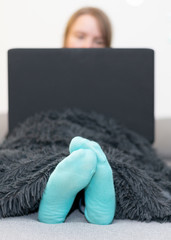 Junge Frau sitzt am Laptop und arbeitet, Quarantäne, Homeoffice, Elearning, AI
