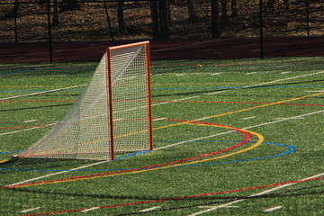 Lacrosse goal on turf field before a game.