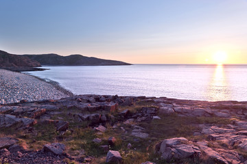 Rocky beach on the shore of the Barents Sea at sunset