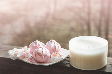 Cozy spring still life: cup of hot tea with spring bouquet of flowers on vintage windowsill with a pink marshmallow. Spring. Apartment.