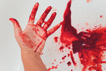 bloody wounds on hand bleeds on a white background.