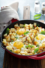 Potato hash with ham, herbs and eggs for breakfast