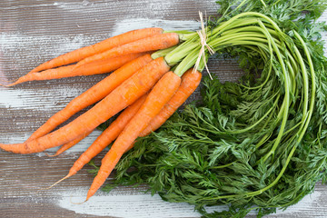 Close up fresh carrots on wooden table
