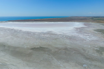 Fototapeta na wymiar Saline Salt Lake in the Azov Sea coast. Former estuary. View from above. Dry lake. View of the salt lake with a bird's eye view