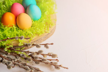 Easter eggs on the grass with willow branches