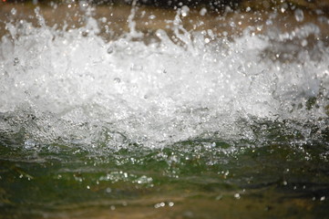 abstract background - water flows in the river. photo stream of water, splashing water, wave