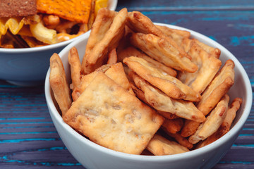 Differnt Types of Junk food, salty-sticks, salty-crackers on wooden table in still-life