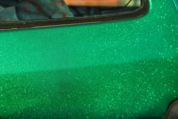 green paint car body film with sparkles shimmers in the sun.
