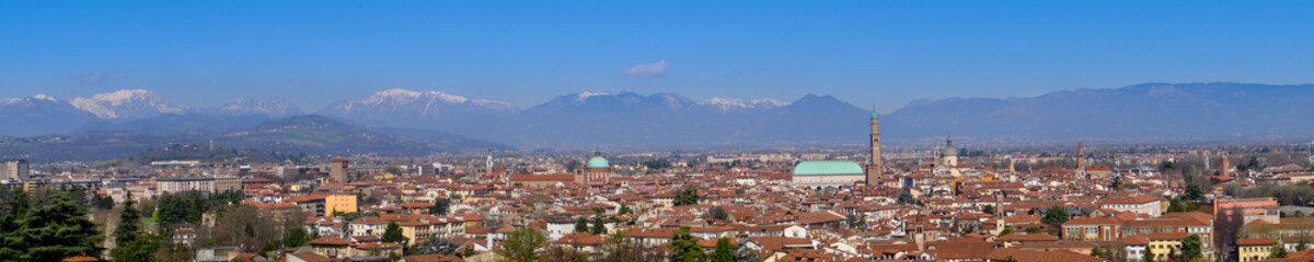 Fototapeta na wymiar wide panorama of the city of Vicenza and the famous monument called Basilica Palladiana with the tall Clock Tower. Vicenza, Veneto, Italy - April 2019