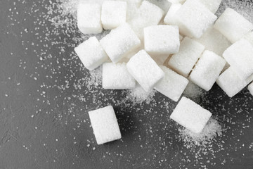 White sugar cubes over black background close up