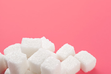 Cubes of sugar on a pink background. Empty space for copying text