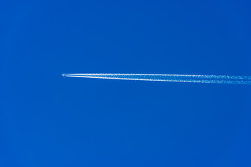 Airliner with contrails - flying in a clear blue sky