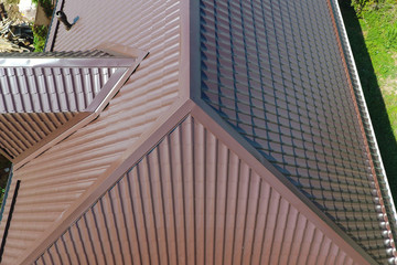 A view from above on the roof of the house. The roof of corrugated sheet. Roofing of metal profile wavy shape