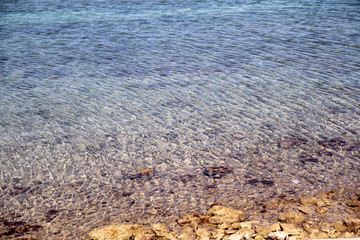 Exotic rocky beach, tropical blue mediterranean sea with waves and sea foam. Beautiful natural environment, panorama, landscape. Idyllic seaside resort in summer season, paradise and amazing scene.