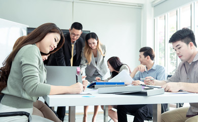 Teamwork business concept .Start up business people in modern office, working together having success. Multiethnic start-up business team on meeting in modern bright office interior brainstorming